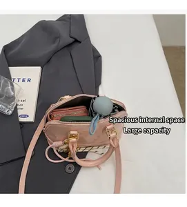 Pink patent leather shell bag showing spacious interior for phone and umbrella