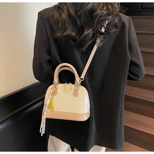 Detail of elegant shell bag with contrast colors and striped scarf accessory