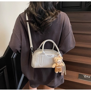 Silver bowling handbag with litchi grain texture and a cute bear plush charm detail