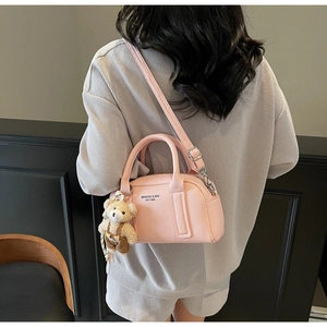 Pink lychee texture bowling bag featuring a cute bear plush charm and silver hardware
