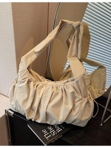 Minimalist beige nylon tote bag with ruched design and knotted strap for daily use