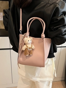 Pink lychee grain leather bucket bag with top handle and cute bear charm for women