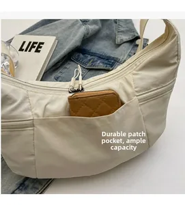 Beige nylon hobo bag showing front pocket storage with wallet for large capacity