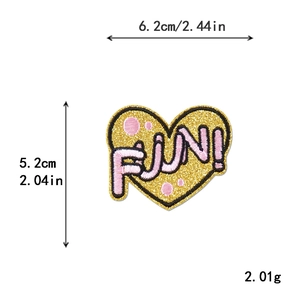 Pink and gold embroidered heart patch with FUN text and dimensions in inches and cm