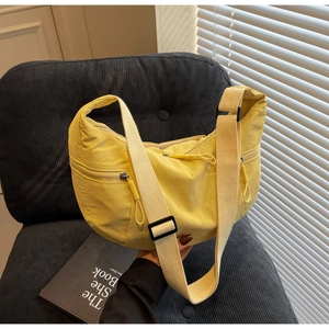 Bright yellow nylon dumpling bag side view showing adjustable strap and zipper details