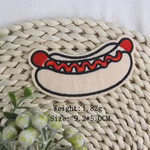 Hot dog embroidered patch 9.2x5.0cm for DIY clothing decoration on a straw mat