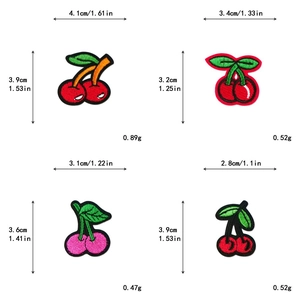 Detailed view of cherry embroidery patches set with distinct stitching textures and colors