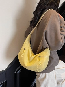 Large yellow dumpling shoulder bag for women with adjustable strap and double front pockets