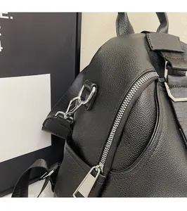 Close-up of black lychee grain faux leather backpack with premium silver metal zippers