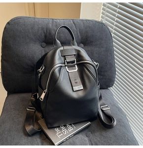 Detailed close-up of high-quality lychee pattern leather texture on a black backpack