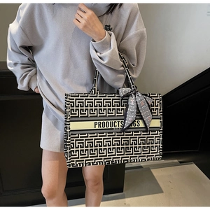Detail view of large canvas tote bag featuring black and white geometric patterns