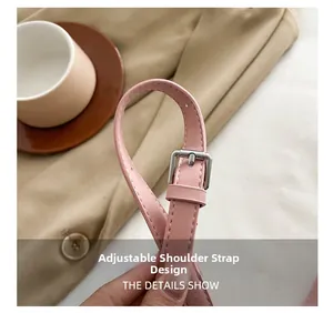 Detail showing adjustable pink leather shoulder strap with silver buckle on handbag