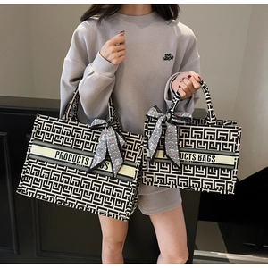 Detail of two jacquard canvas tote bags with geometric patterns and silk scarf decor