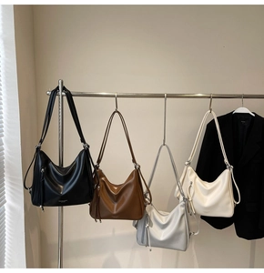 Detail showing Hobo bags in black, brown, silver, and cream with side zipper accents