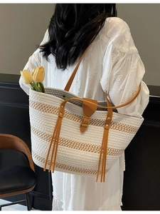 Retro striped straw tote bag with floral accents and leather handles for beach outings