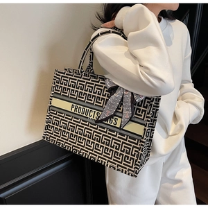 Detail of canvas tote bag with geometric maze pattern and elegant twilly scarf handle