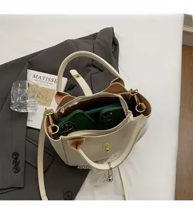 Internal view of cream lychee leather bucket bag showing spacious interior for two phones