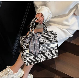 Detail showing high-quality canvas tote bag with black and white geometric pattern