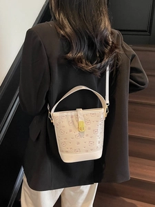 Chic cream white bucket bag with embossed cartoon bear patterns and gold clasp