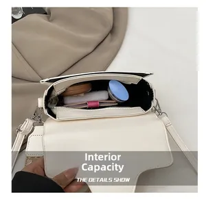 Detailed interior view of a contrast saddle bag showing large capacity and compartments