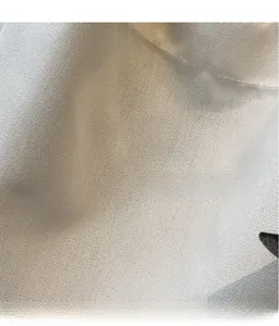 Close-up of lightweight off-white canvas fabric showing high-quality fine weave texture