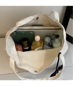 Interior view showing the large capacity of the beige canvas tote bag with daily items