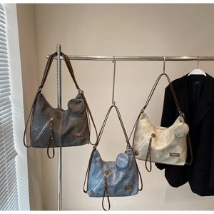 Three vintage denim-style tote bags in grey, blue, and beige with mini pouches
