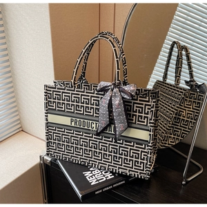Detail of the geometric maze pattern canvas tote bag with silk scarf on the handle