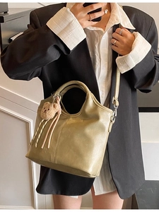 Olive green bucket bag with cute plush bear charm and detachable crossbody strap