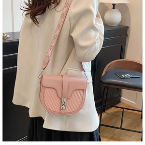 Pink saddle bag featuring contrast textures and chic jacquard embroidered strap details