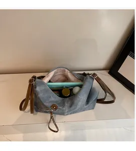 Top view of spacious interior with pink monogram lining and brown leather strap details