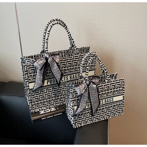 Detailed set of large and small canvas tote bags with geometric pattern and ribbon
