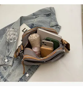 Top view of taupe nylon crossbody bag interior showing large capacity for daily items