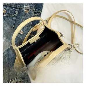 Internal view of cream bow shoulder bag showing capacity for phone and cosmetics