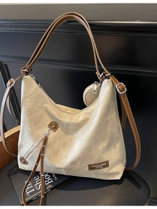 Vintage canvas and leather tote bag with large capacity and decorative side tassel