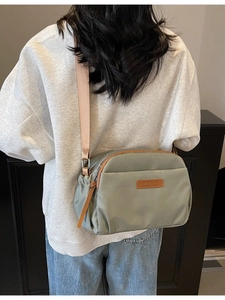 Minimalist olive green nylon crossbody bag with large capacity and adjustable wide strap