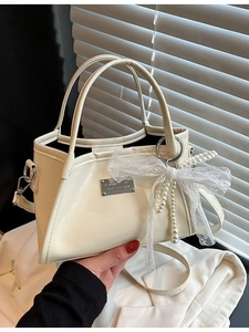 Elegant cream white trapezoid shoulder bag with lace bow and golden nameplate