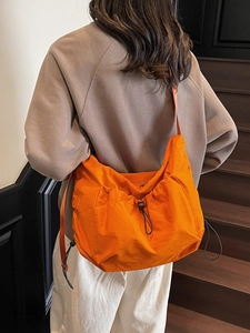 Fashionable orange pleated shoulder bag with adjustable drawstring and large capacity