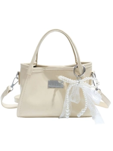 Cream bow accent faux leather hobo bag with pearl lace charm and shoulder strap