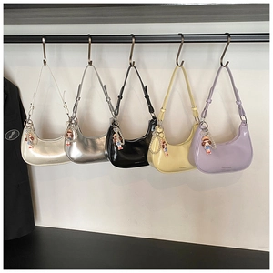 Detailed close-up of crescent underarm bags in five colors with cute doll charms