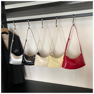 Rows of glossy patent leather hobo bags in silver, black, cream, yellow, and red colors