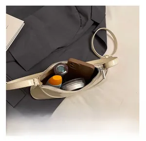 Internal view showing storage capacity for essentials in beige patent leather bag
