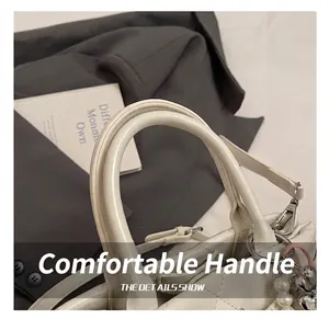Gros plan détaillé sur la poignée ronde épaisse d'un sac seau en cuir matelassé