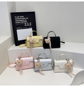 Multiple textured synthetic leather crossbody bags with bear charms in five stylish colors