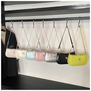 Close-up of modern bucket bags collection in various colors with metallic buckles