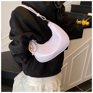 Detail of light purple moon hobo bag with pearl bead charm and fashion print text