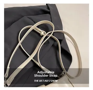 Detail shot of the adjustable white oil-wax leather shoulder strap with a metal buckle