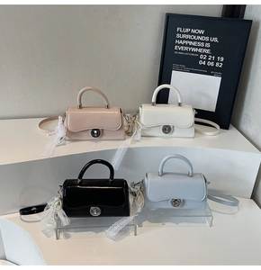 Close-up of stylish mini square bags in four colors with pearl lace and metal twist locks