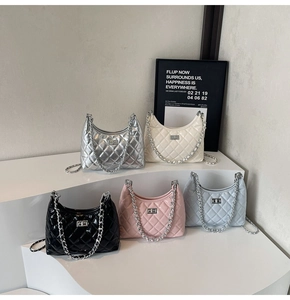 Close-up of quilted crescent chain bags in silver, beige, black, pink and blue