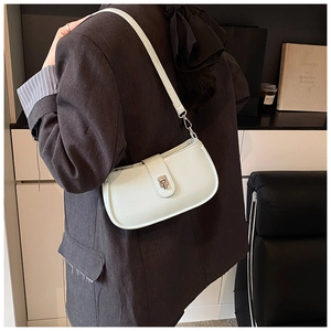 Detail view of mint green oil wax leather shoulder bag with a silver square buckle closure